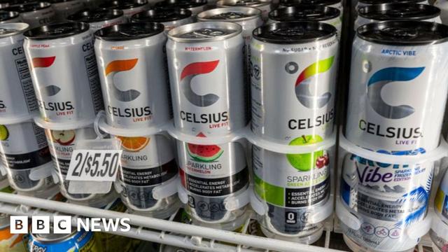 White cans of Celsius are sitting in a fridge