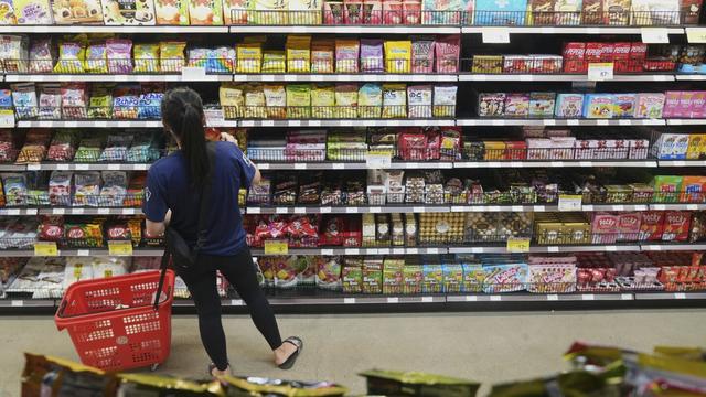 A customer buys Chinese made ginger candy at 99 Ranch Market, an Asian grocery store in Los Angeles, April 7, 2025. (AP Photo/Damian Dovarganes, File)