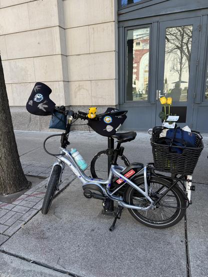 Bike parked by a bike rack in front of the library