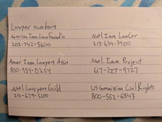 The back of the index card has phone numbers for various national lawyer groups that can help with immigration issues.